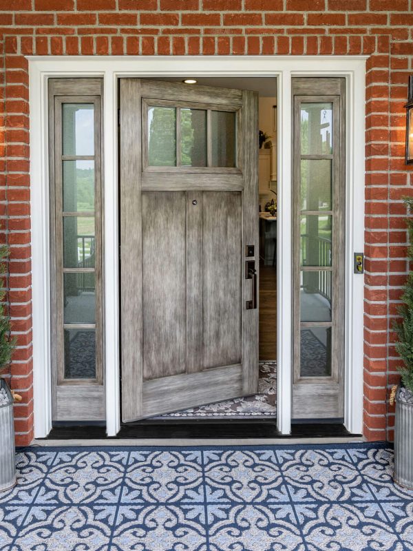 Brick entrance with open wooden door.