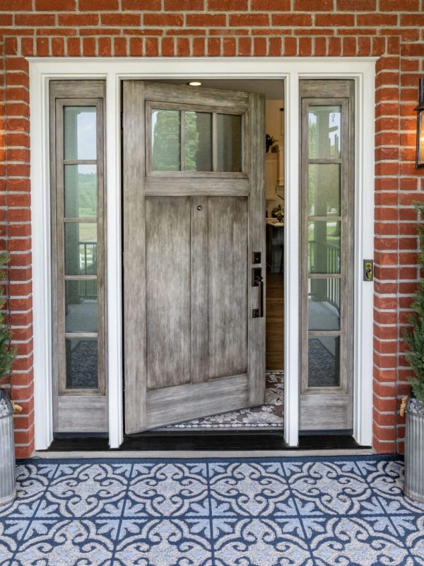 Brick entrance with open wooden door.